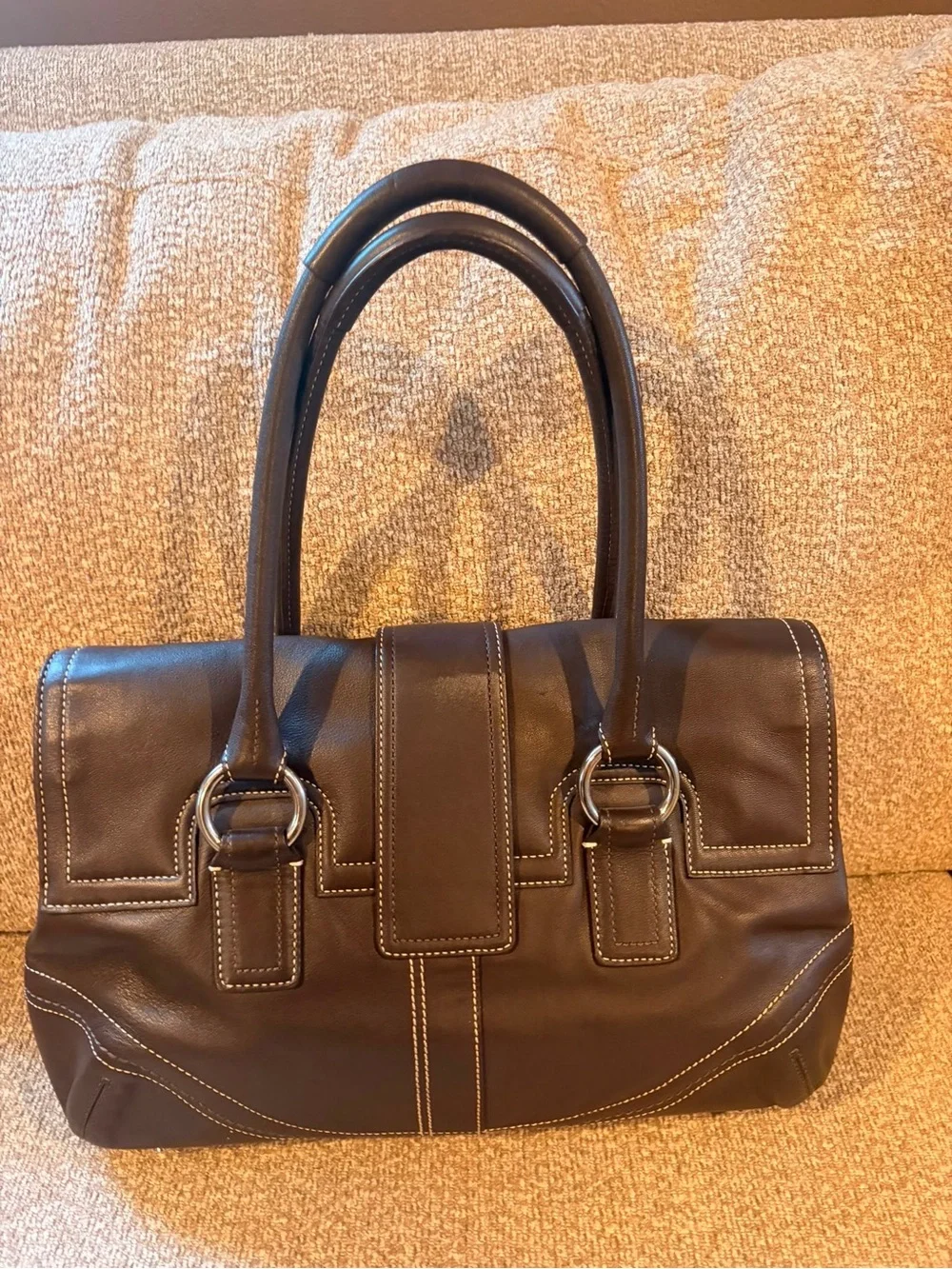Coach Dark Brown Leather Buckle Satchel with Contrast Stitching.